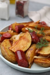 Photo of Delicious baked potato with thin dry smoked sausages, onion and dill on table, closeup