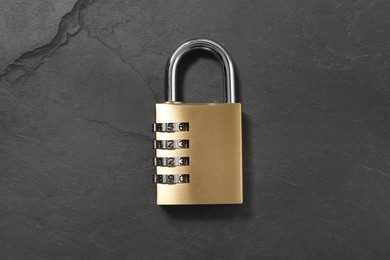 One steel combination padlock on black table, top view