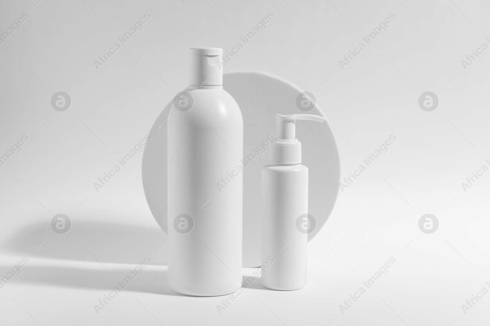 Photo of Bottles with cosmetic products on white background