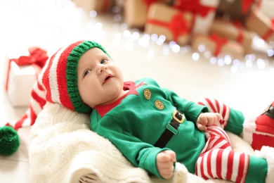 Photo of Cute baby in Christmas costume at home