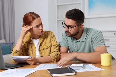 Couple doing taxes at table in room