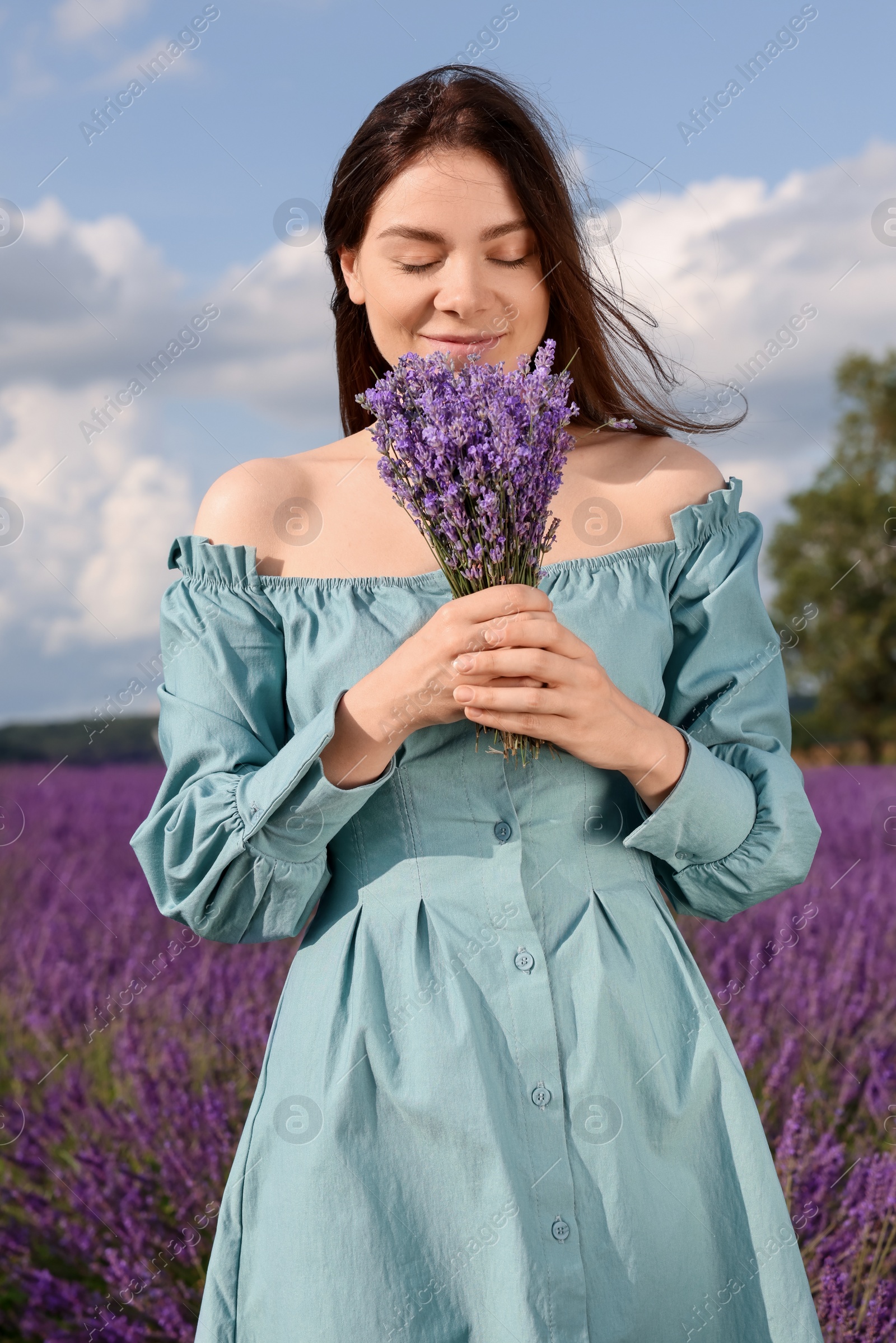 Photo of Beautiful woman with bouquet in lavender field