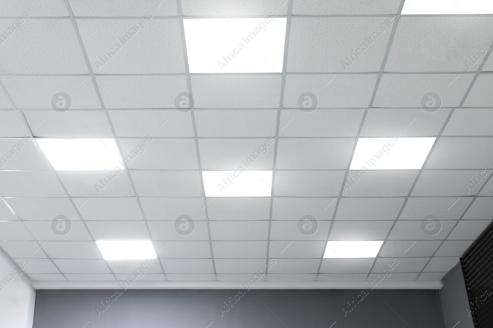 Photo of White ceiling with lighting in office room