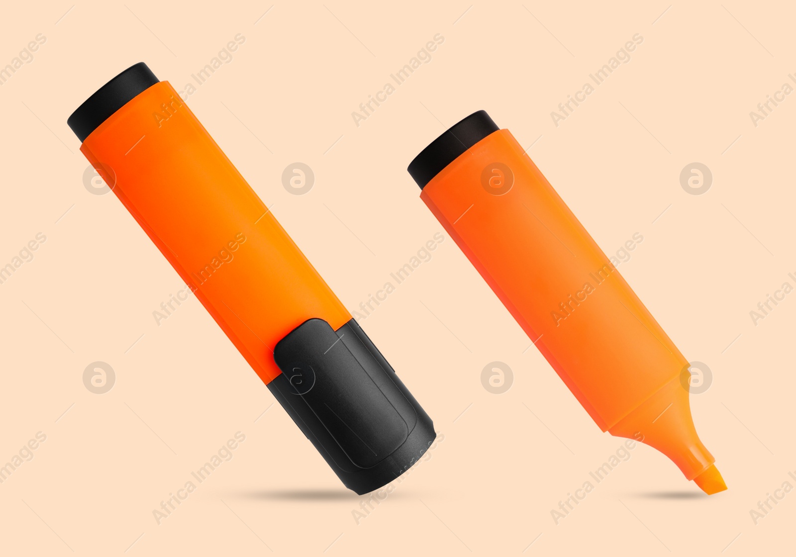 Image of Two orange markers on beige background. Highlighter