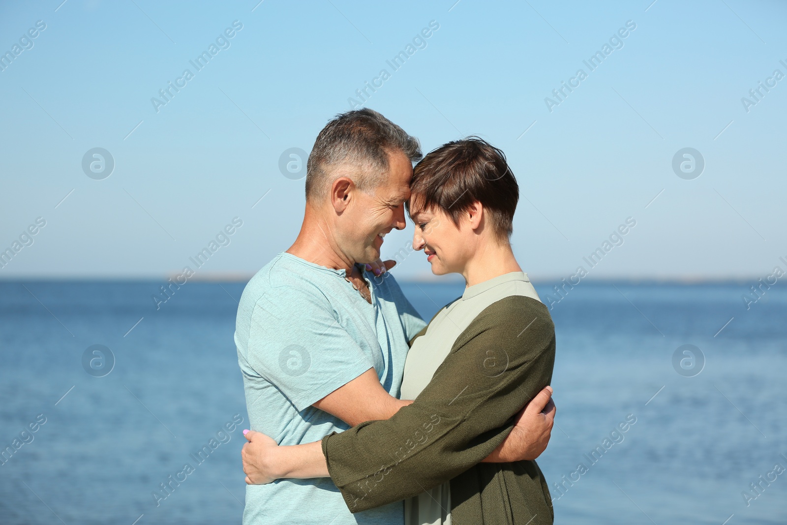 Photo of Happy mature couple at beach on sunny day