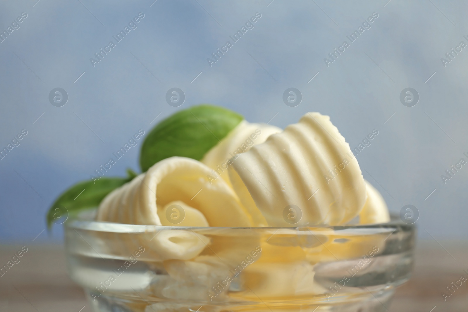 Photo of Bowl with tasty butter curls, closeup