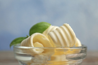 Photo of Bowl with tasty butter curls, closeup