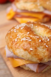 Photo of Delicious bagels with ham and cheese on table, closeup