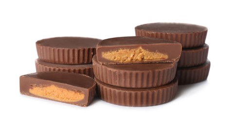 Cut and whole peanut butter cups isolated on white