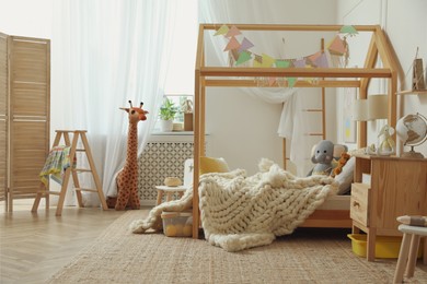 Photo of Stylish child room interior with house bed