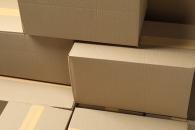 Many cardboard boxes as background, closeup. Packaging goods