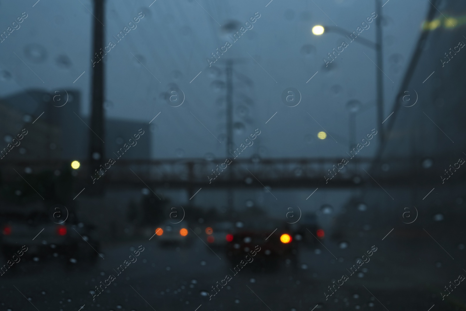 Photo of Road on rainy day, view through car window with water drops