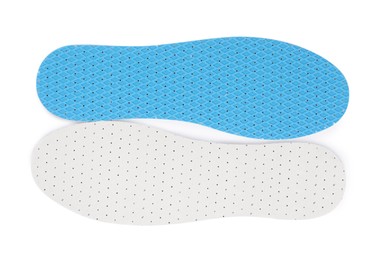 Pair of insoles on white background, top view