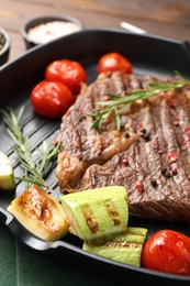 Photo of Delicious grilled beef steak and vegetables on table, closeup