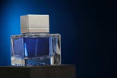 Luxury men`s perfume in bottle against dark background, space for text