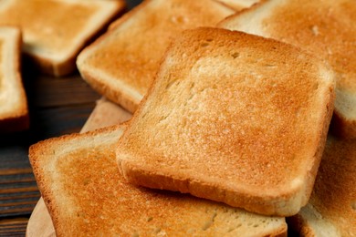 Photo of Slices of tasty toasted bread on table, closeup