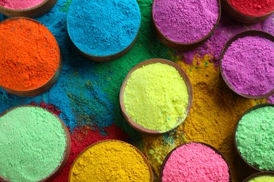Photo of Colorful powder dyes as background, top view. Holi festival