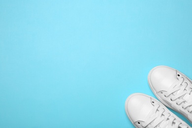 Flat lay composition of stylish shoes on color background, space for text
