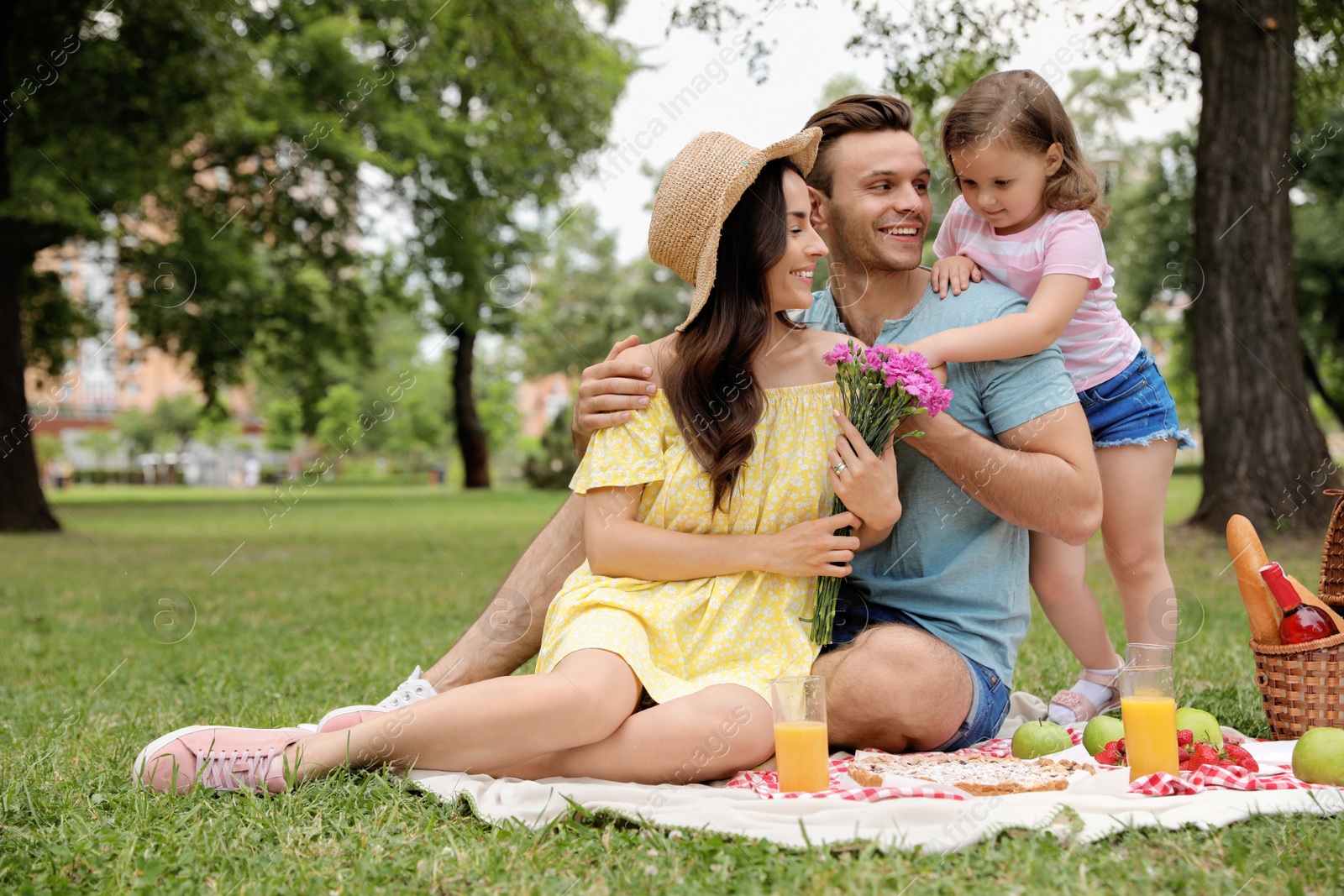 Photo of Happy family having picnic in park on summer day