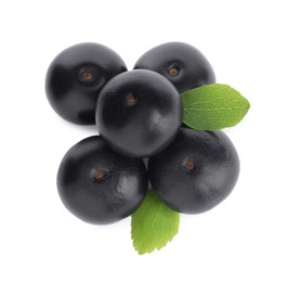 Pile of fresh ripe acai berries and green leaves on white background, top view