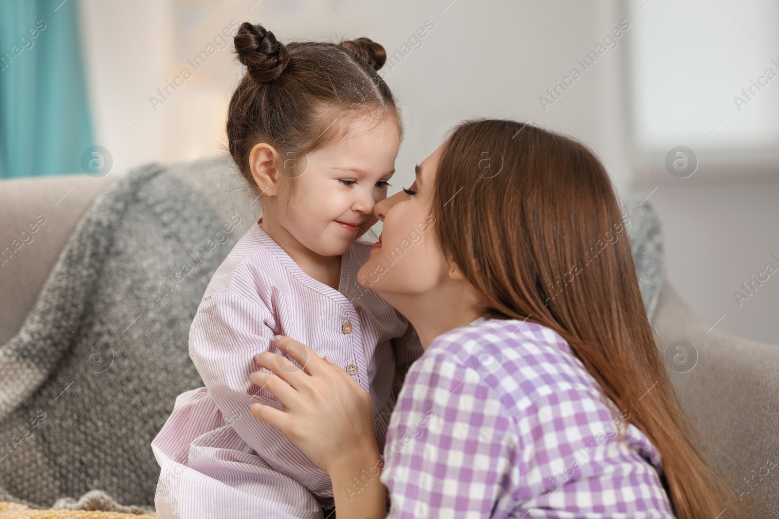 Photo of Young mother with little daughter at home