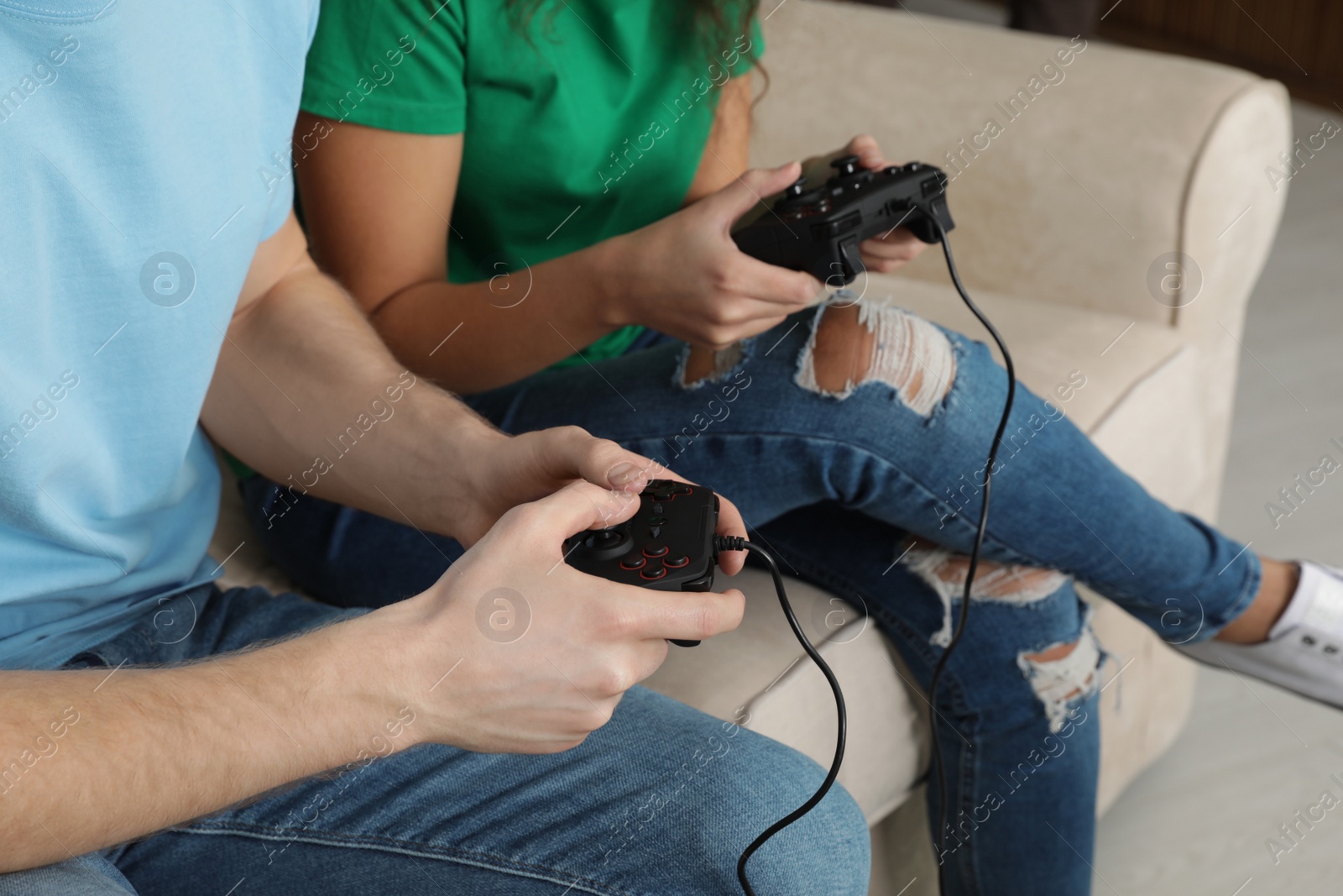 Photo of Young couple playing video games at home, closeup