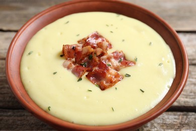 Photo of Tasty potato soup with bacon in bowl on table, closeup