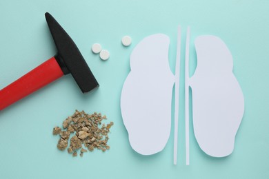 Photo of Flat lay composition of kidneys paper cutout with stones on turquoise background