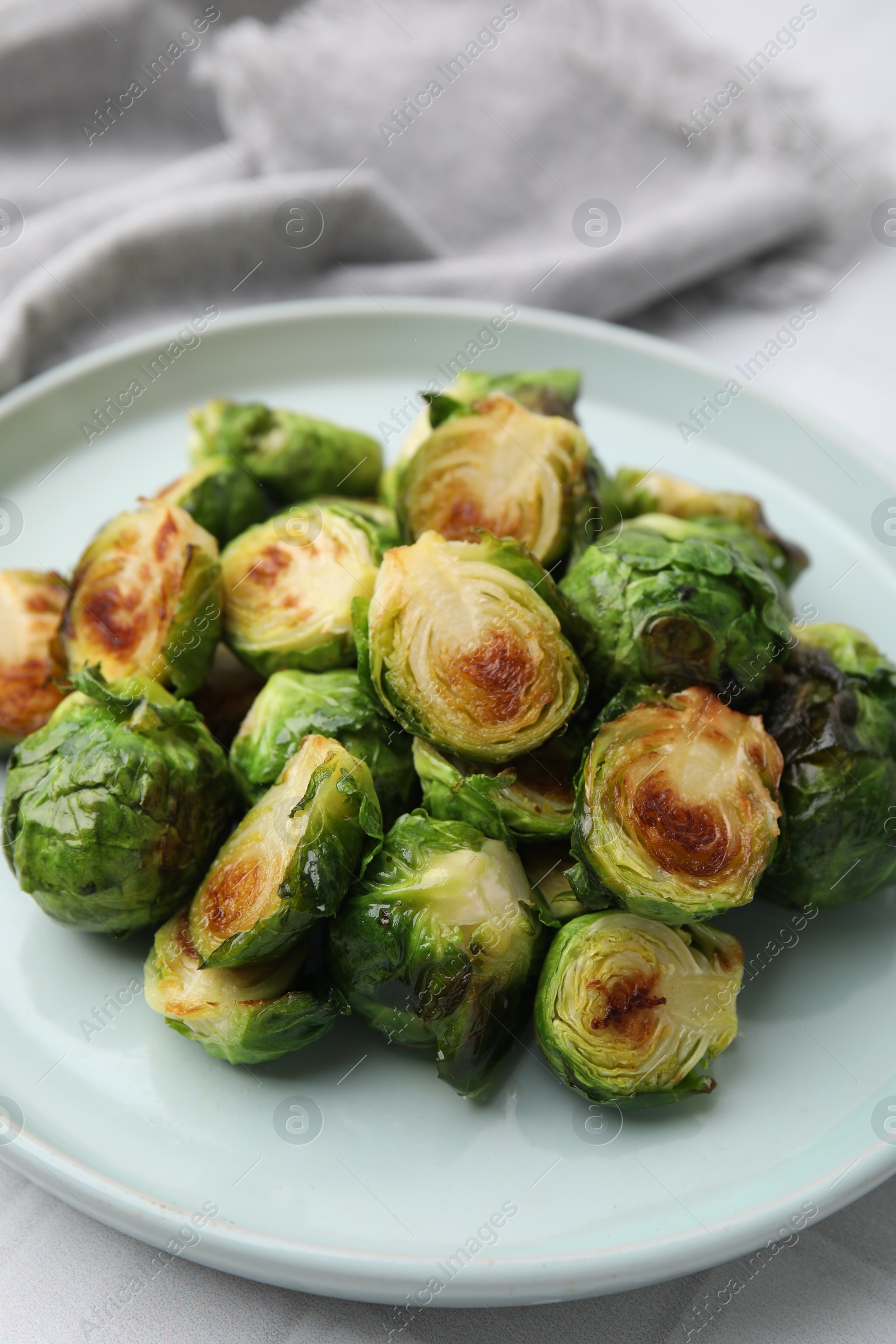 Photo of Delicious roasted Brussels sprouts on white table