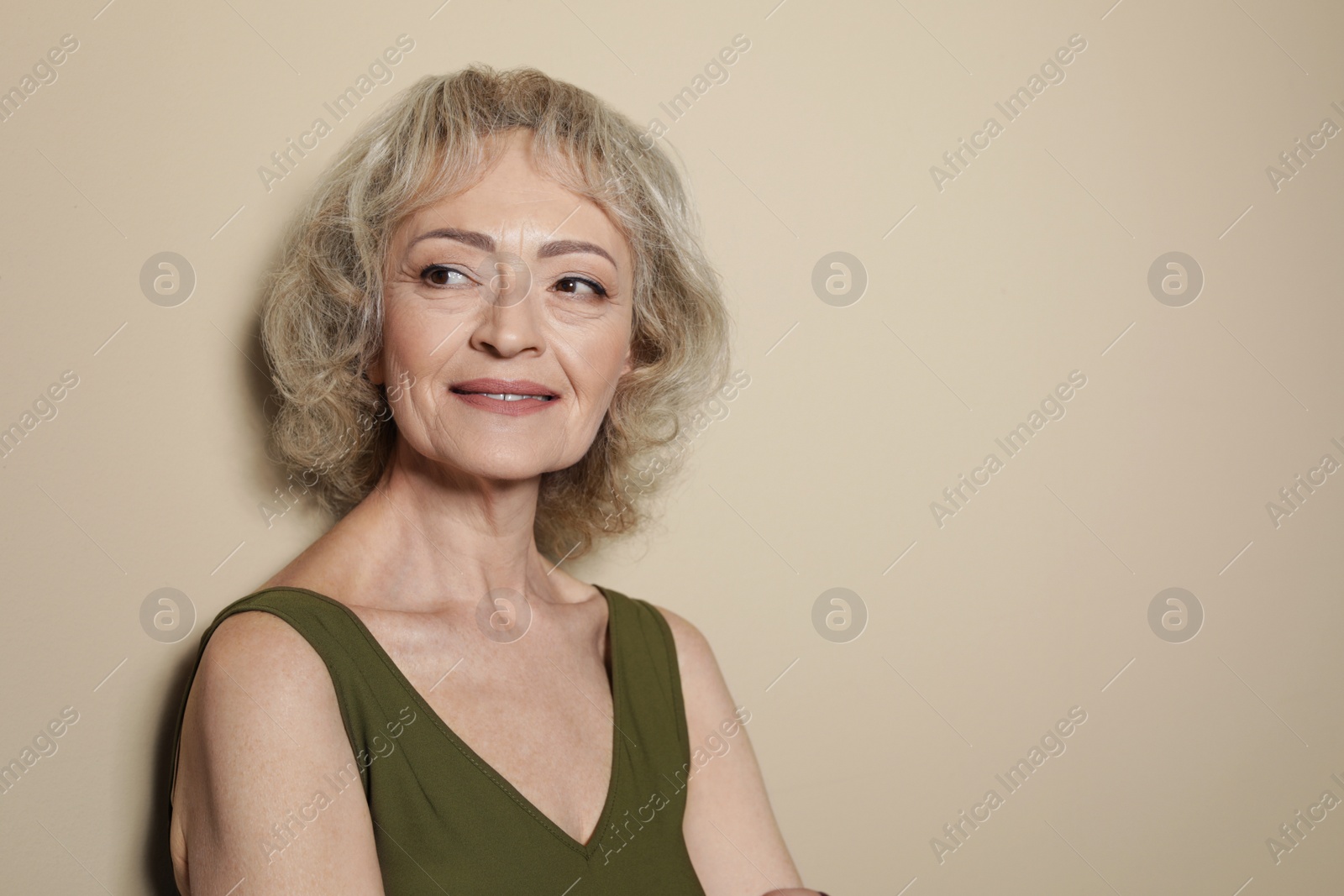 Photo of Portrait of mature woman on color background. Space for text