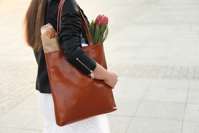 Photo of Woman with leather shopper bag outdoors, closeup