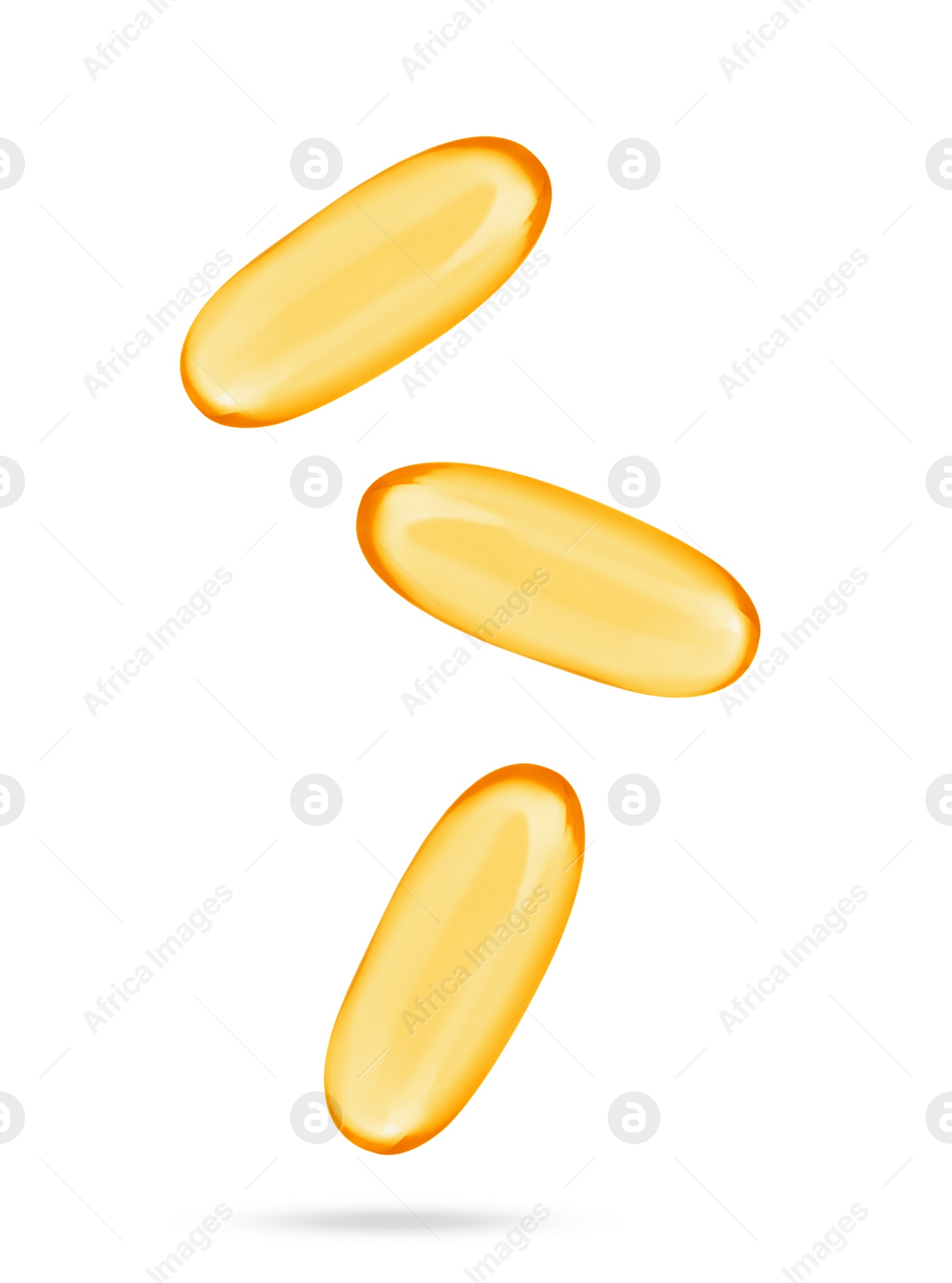 Image of Vitamin. Softgel capsules falling on white background