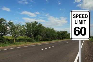 Traffic sign SPEED LIMIT 60 near empty asphalt road on sunny day