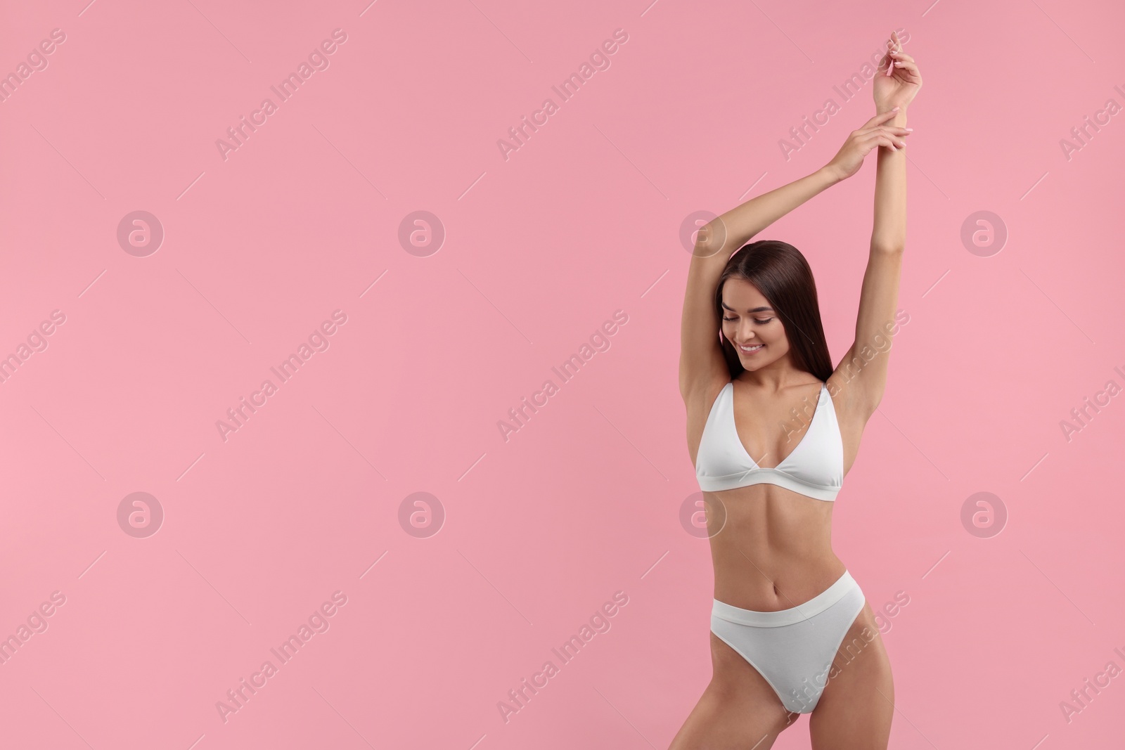 Photo of Young woman in stylish white bikini on pink background. Space for text