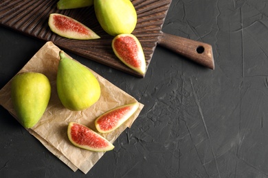 Photo of Fresh ripe figs on dark background. Tropical fruit