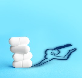 Doping concept. White pills and silhouette of gymnast on turquoise background
