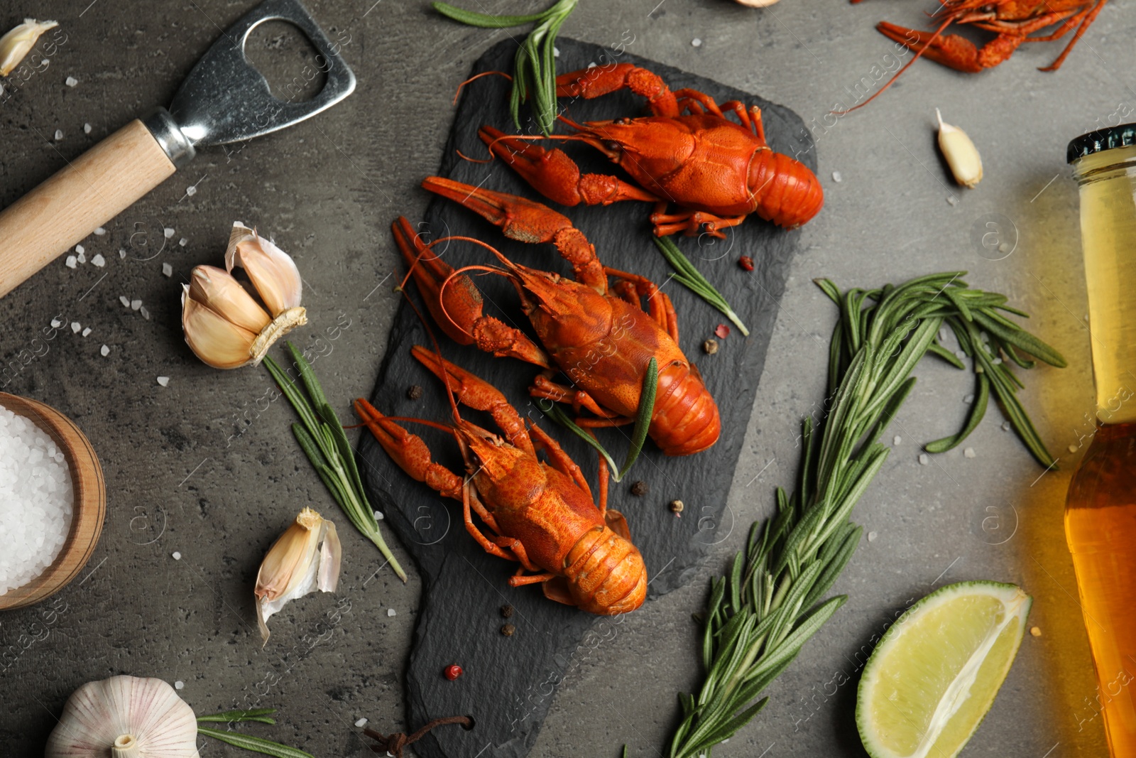 Photo of Flat lay composition with delicious red boiled crayfishes on black table