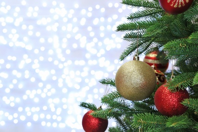 Christmas tree with festive decor against blurred fairy lights