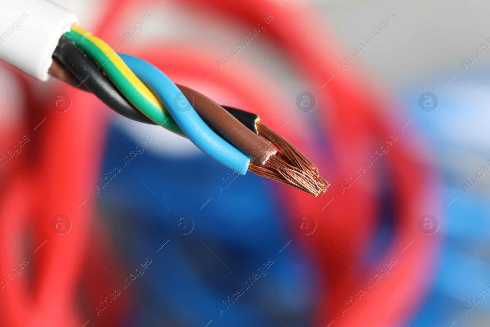 Photo of Colorful electrical wire on blurred background, closeup