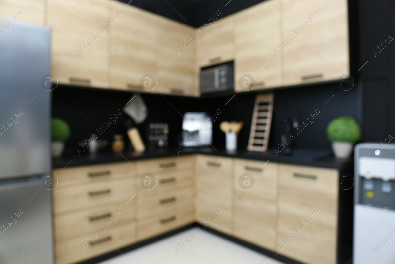 Photo of Blurred view of kitchen interior with modern furniture