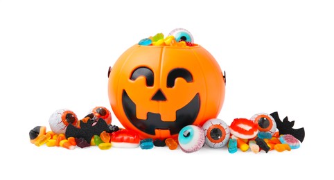 Halloween trick or treat bucket with different sweets on white background