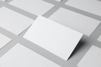 Photo of Blank business cards on light gray background, closeup. Mockup for design