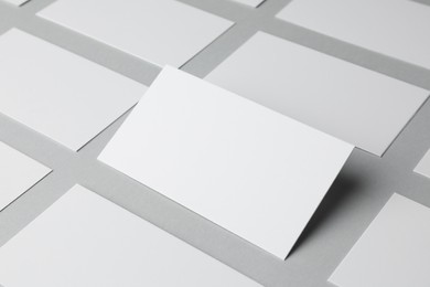 Blank business cards on light gray background, closeup. Mockup for design