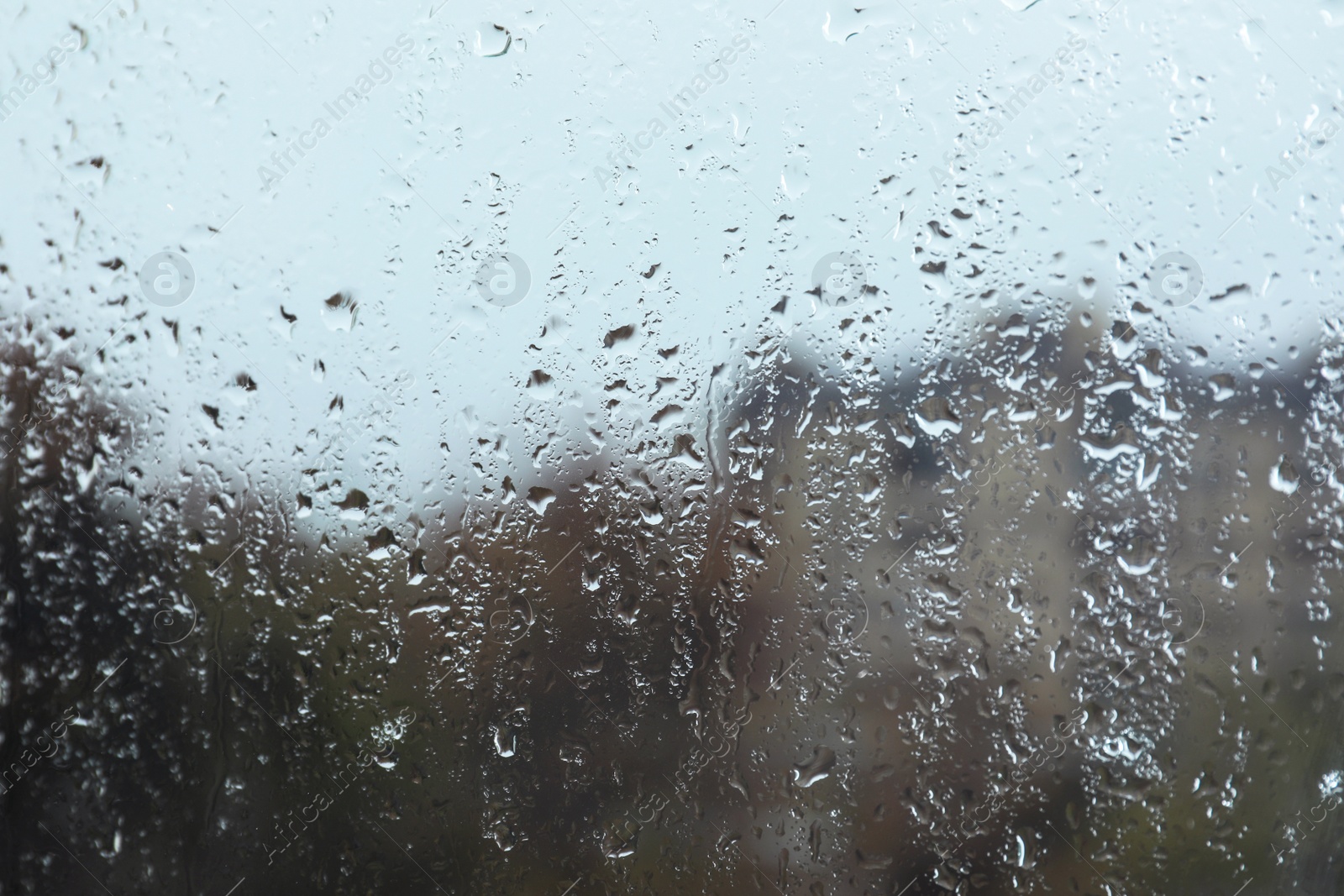 Photo of Rain drops on window glass as background, closeup