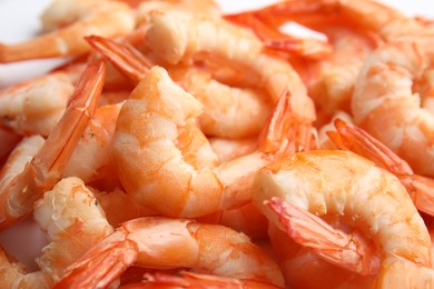 Photo of Pile of delicious peeled shrimps as background, closeup