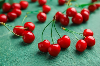 Photo of Sweet red cherries on wooden table