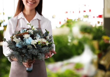 Florist holding beautiful wedding bouquet in flower shop, closeup. Space for text 