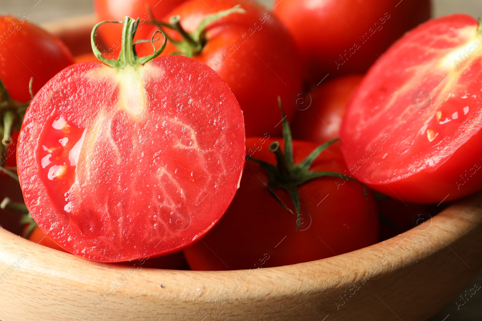 Photo of Fresh ripe tomatoes in bowl, closeup view