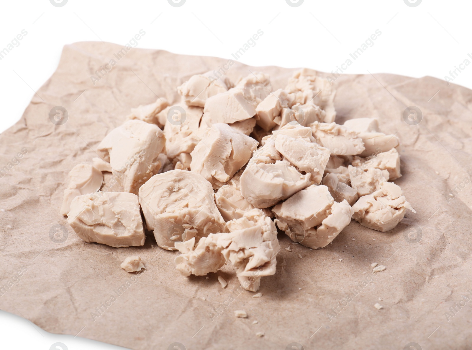 Photo of Pieces of compressed yeast on parchment paper, closeup