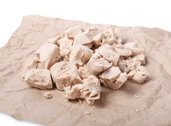 Pieces of compressed yeast on parchment paper, closeup